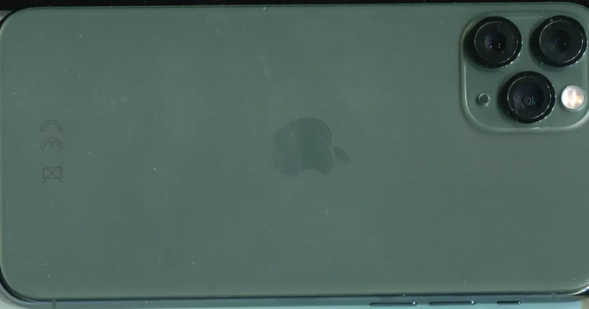 Back of a dark green iPhone 11 Pro lying on its side, showing the Apple logo and the triple camera
