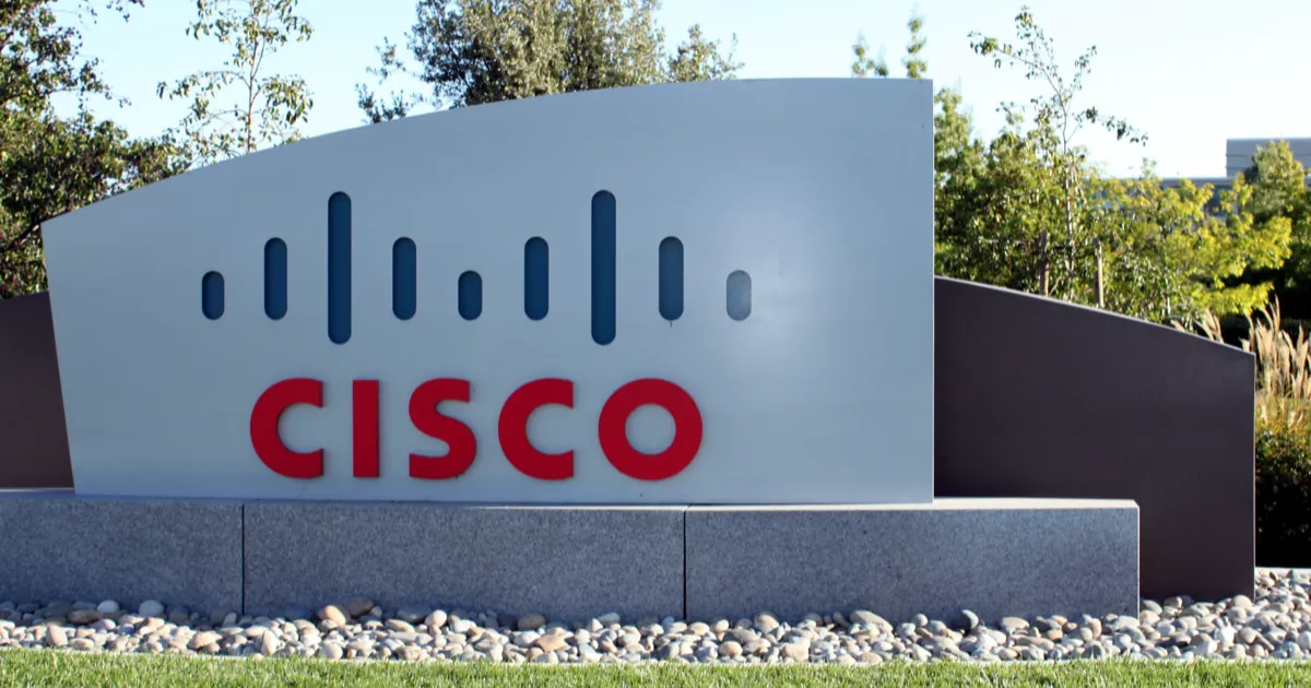 Cisco logo sign with the company's blue bars and red lettering on a stone base outside its San Jose campus