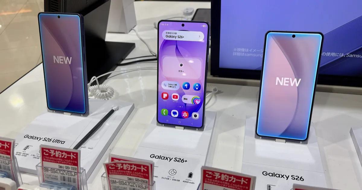 Galaxy S26 Ultra, S26+ and S26 phones on display stands in a Japanese electronics store, with preorder cards in front