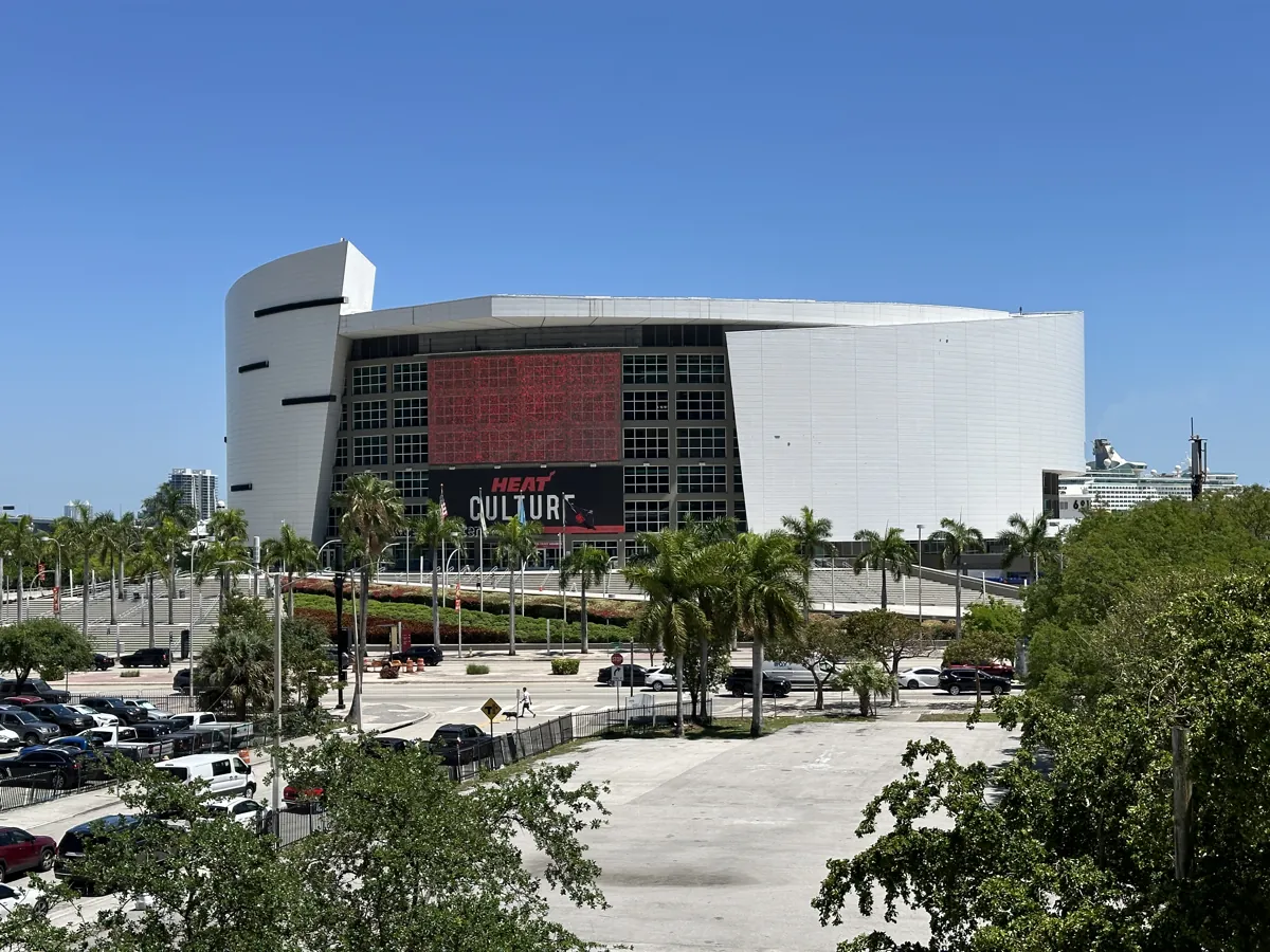 Kaseya Center, the Miami Heat's arena, seen from across a parking lot in downtown Miami on a sunny day