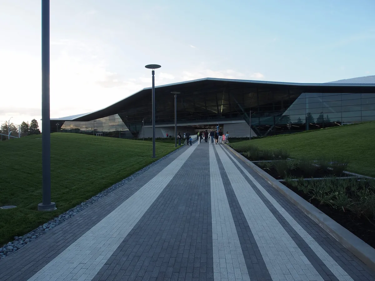 Landscaped walkway leading to the entrance of Nvidia's Endeavor building in Santa Clara, with visitors near the doors