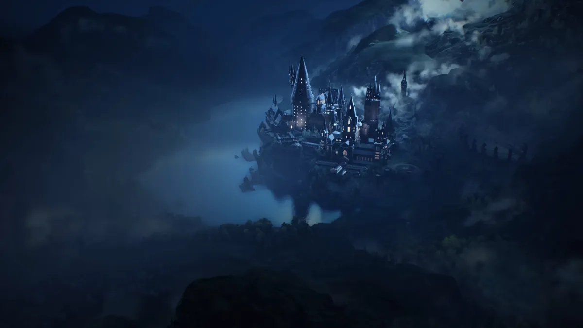 Hogwarts castle at night on a misty cliff, a scene from the game Hogwarts Legacy