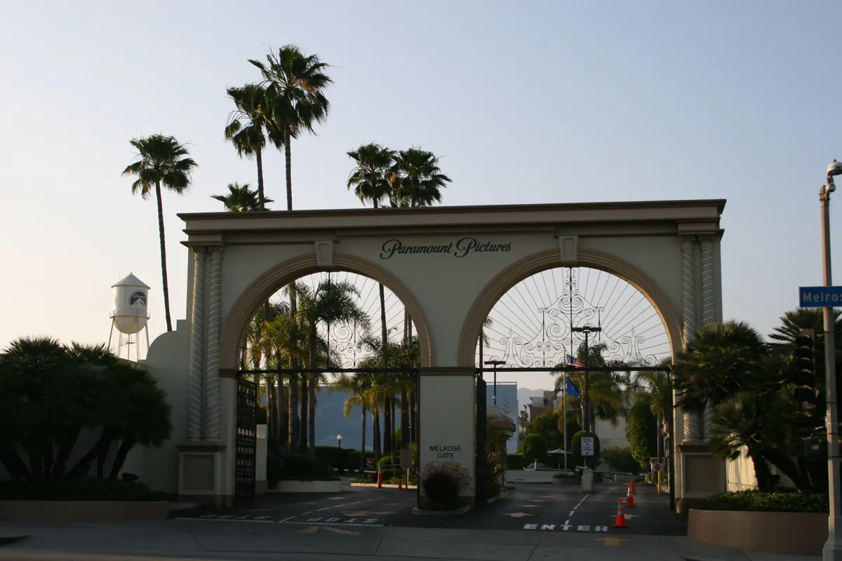 The arched Melrose Gate entrance to the Paramount Pictures lot in Hollywood, with palm trees behind it