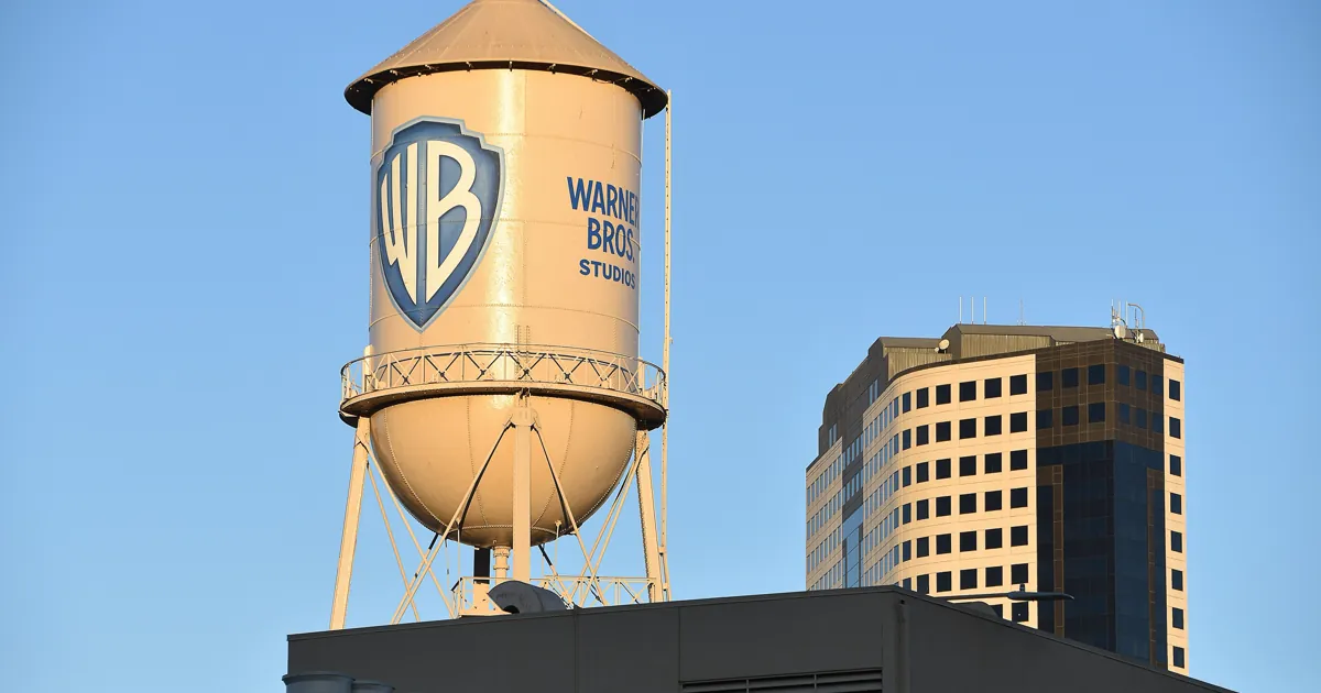 The Warner Bros. Studios water tower with the WB shield against a blue sky in Burbank