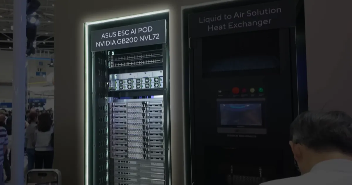 An Nvidia GB200 NVL72 server rack on show at Computex 2024, lit from the edges, beside a liquid cooling cabinet