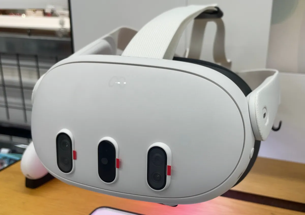 A white Meta Quest 3 headset seen from the front, with three camera openings on its visor