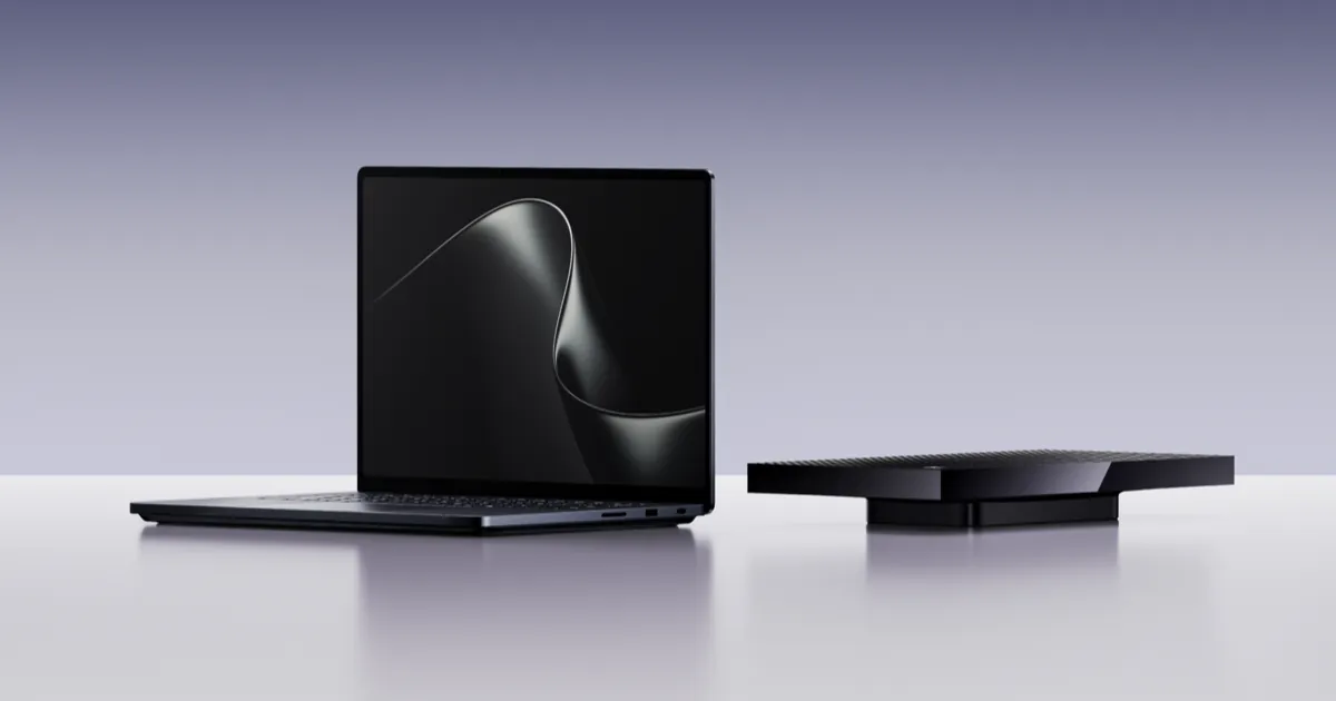 Surface Laptop Ultra open on a white table beside a flat black box