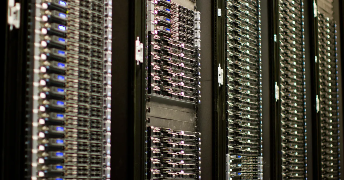 Rows of rack-mounted servers with blue status lights in a Wikimedia Foundation data center