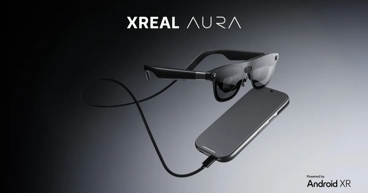 Black XREAL Aura glasses connected by a braided cable to their phone-sized compute puck, with the Android XR logo